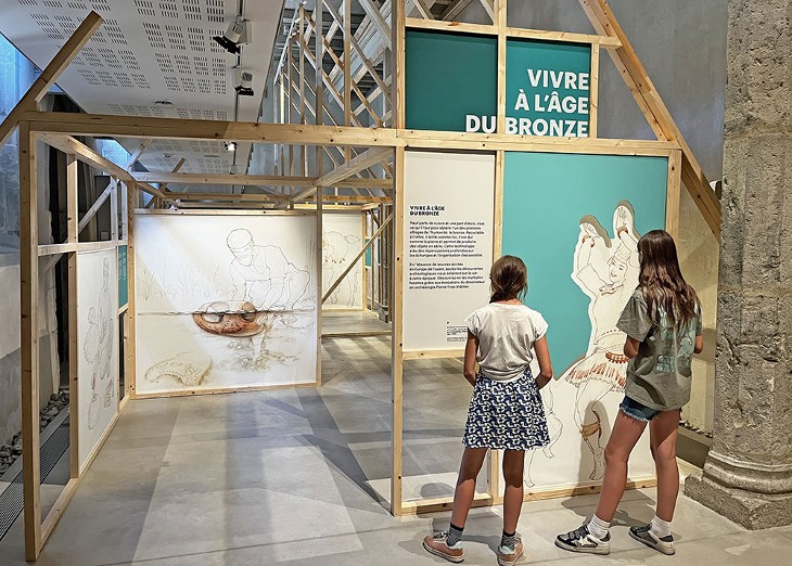 Vue de l'exposition "Bronze, l'âge retrouvé" au Musée Savoisien avec deux adolescentes en visite.